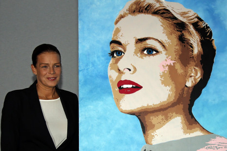 Princess Stephanie of Monaco (L), president of Fight Aids Monaco, poses next to a painting of her mother Princess Grace