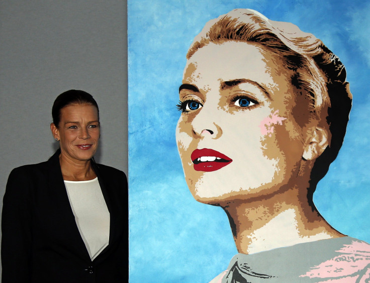 Princess Stephanie of Monaco (L), president of Fight Aids Monaco, poses next to a painting of her mother Princess Grace