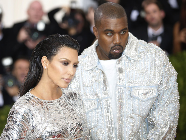 Kanye West (R) and wife Kim Kardashian