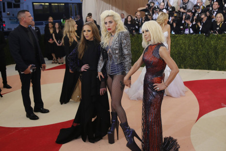 Singer-songwriter Lady Gaga shows off an insane pair of shoes poses along with designer Donatella Versace
