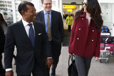 Lawyer Amal Clooney walks with the deposed President of the Maldives Mohamed Nasheed