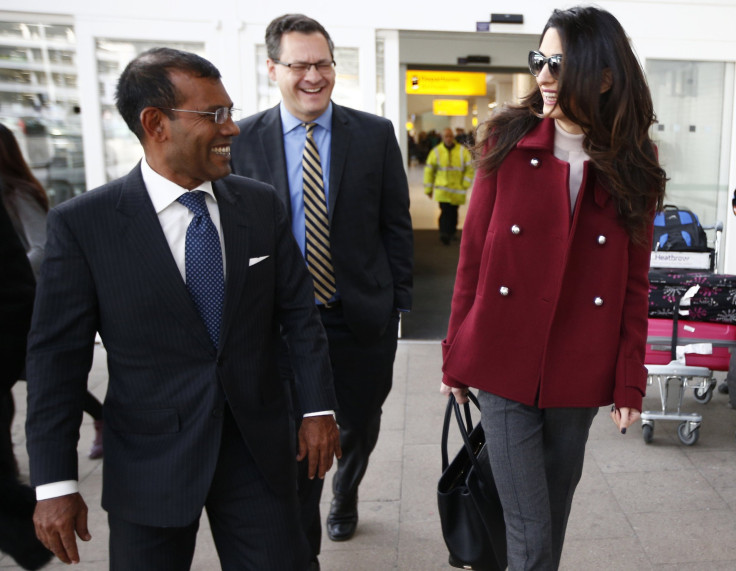 Lawyer Amal Clooney walks with the deposed President of the Maldives Mohamed Nasheed