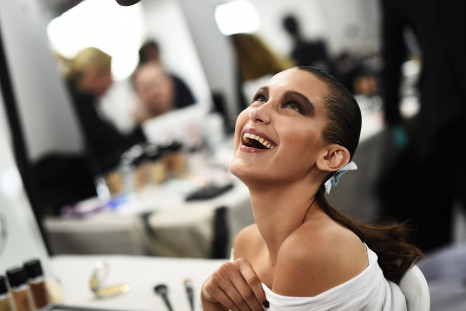 Bella Hadid smiles as she has her make-up applied inside Blenheim Palace