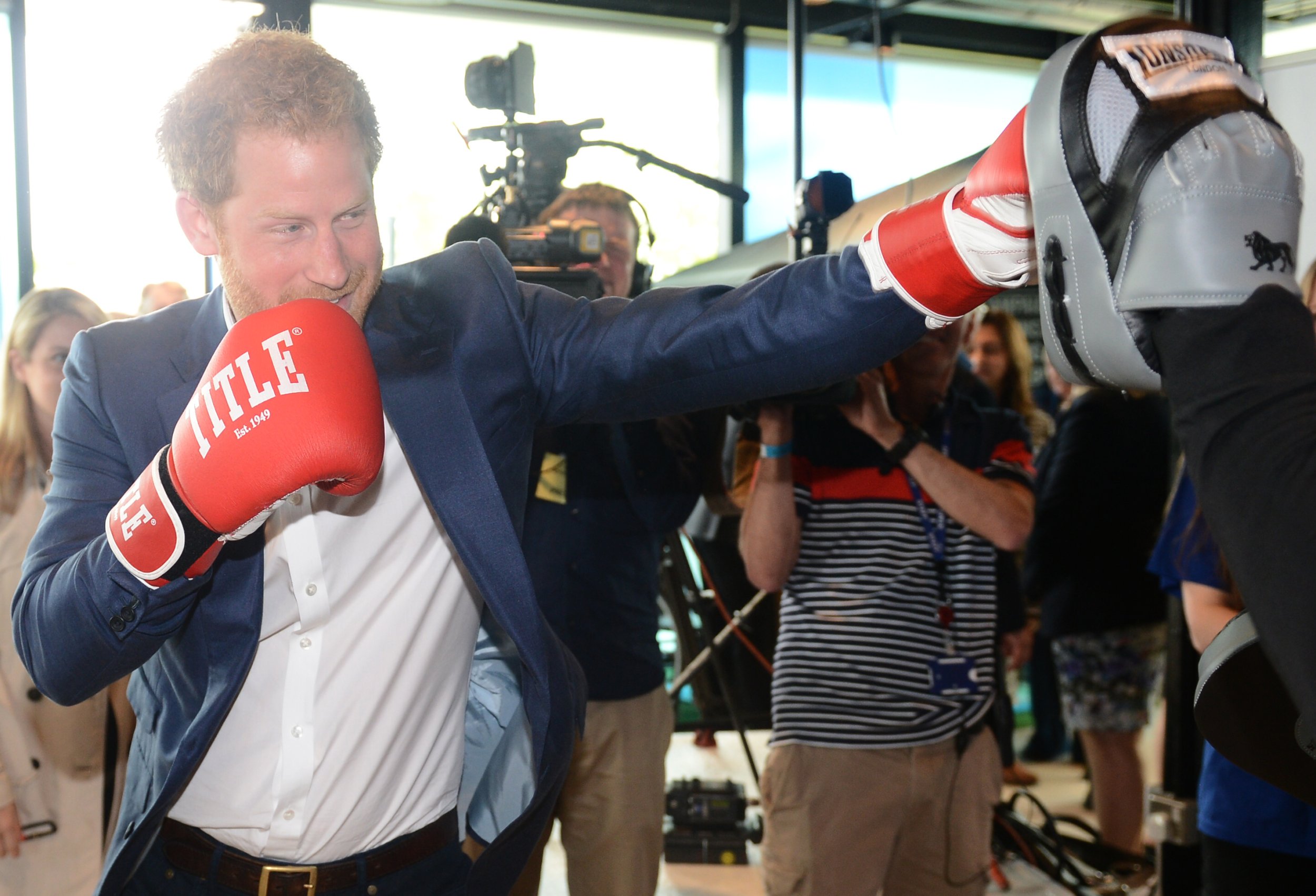 Prankster Prince Harry Strikes Out His Tongue As He Photobombs Canadian