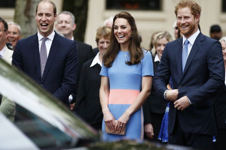 Prince William, the Duchess of Cambridge and Prince Harry (R) 