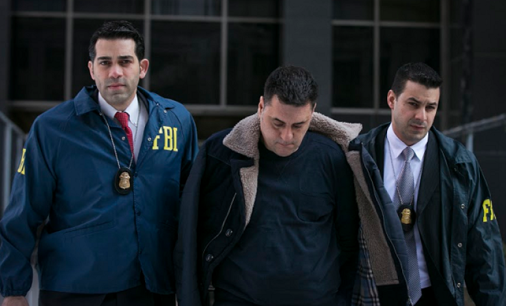 Gambino family associate Franco Lupoi (C) is escorted by FBI agents from their Manhattan offices in New York February 11, 2014. 
