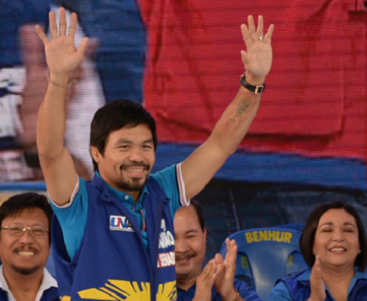  Senatorial candidate of the opposition party and boxing icon Manny Pacquiao greets supporters during his party's proclamation rally in Manila on February 9, 2016.