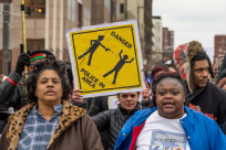 CLEVELAND, OH - DECEMBER 29: Katy Kostenko (Holding sign), a 19-year old resident of Cleveland, marches with other activists on St Clair Ave. on December 29, 2015 in Cleveland, Ohio.