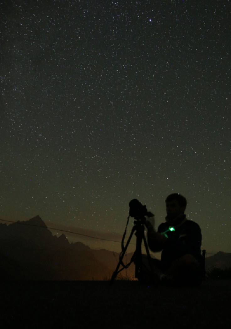 A photographer prepares to take pictures of the annual Perseid meteor shower in the village of Crissolo, near Cuneo, in the Monviso Alps region of northern Italy, on August 13, 2015. 
