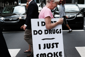 PHILADELPHIA, PA - JULY 28: A woman walks with a sign supporting legalizing marijuana during the Democratic National Convention (DNC) on July 28, 2016 in Philadelphia, Pennsylvania.