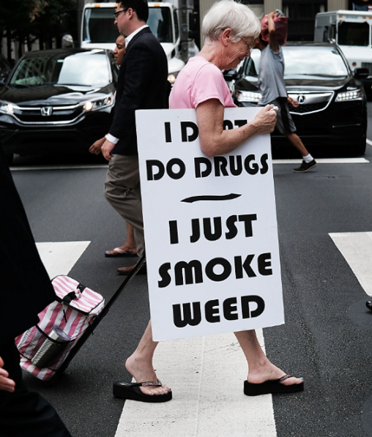 PHILADELPHIA, PA - JULY 28: A woman walks with a sign supporting legalizing marijuana during the Democratic National Convention (DNC) on July 28, 2016 in Philadelphia, Pennsylvania.