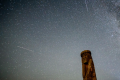Shooting stars cross the night sky over a wooden idol near the village of Ptich some 25km away from Minsk, during the peak of the annual Perseid meteor shower on August 15, 2015.