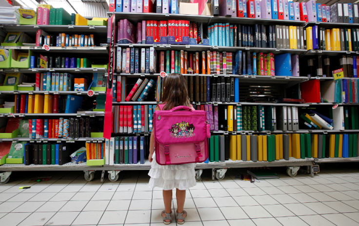 A young girl looks at school stationery in a supermarket in Nice August 23, 2012.