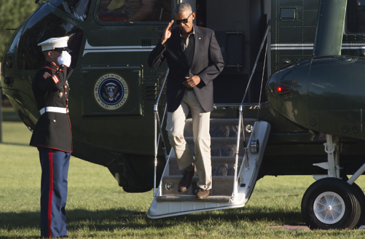 TOPSHOT - US President Barack Obama exits Marine One upon arrival on the South Lawn of the White House in Washington, DC, August 23, 2016