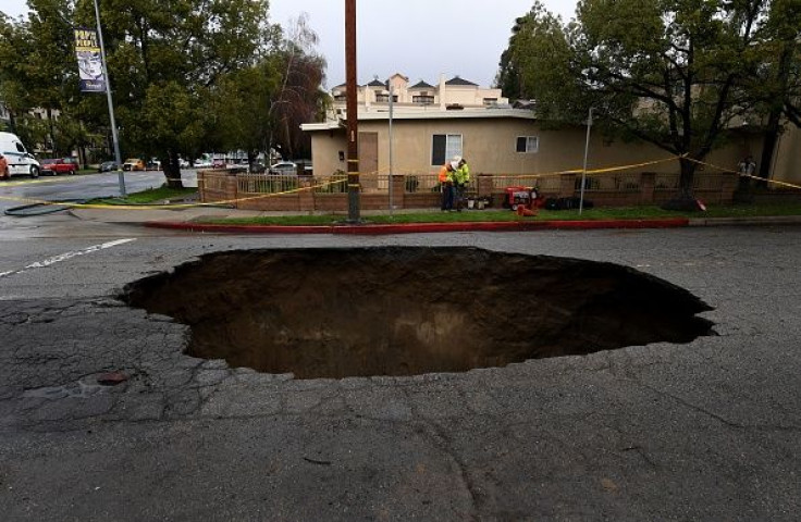 Motorist falls into sinkhole 