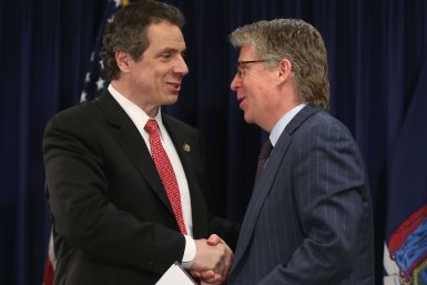 Andrew Cuomo (L) shakes hands with Manhattan District Attorney Cy Vance