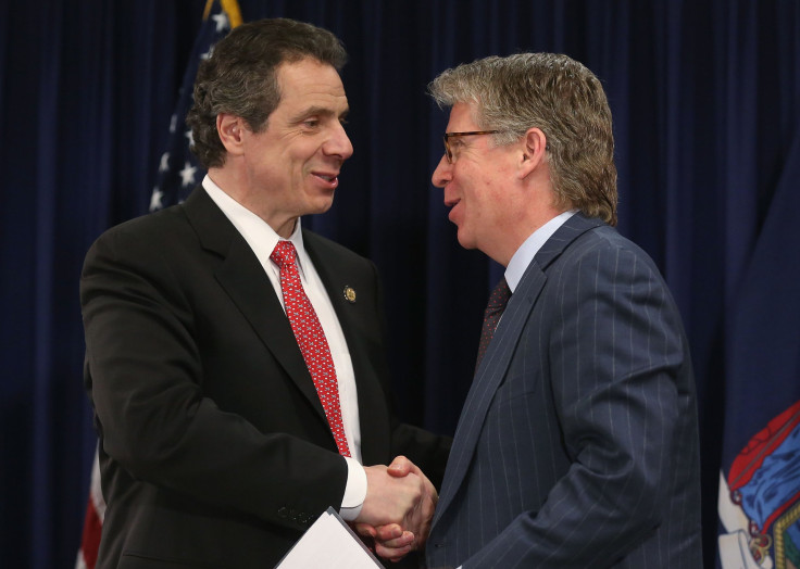 Andrew Cuomo (L) shakes hands with Manhattan District Attorney Cy Vance