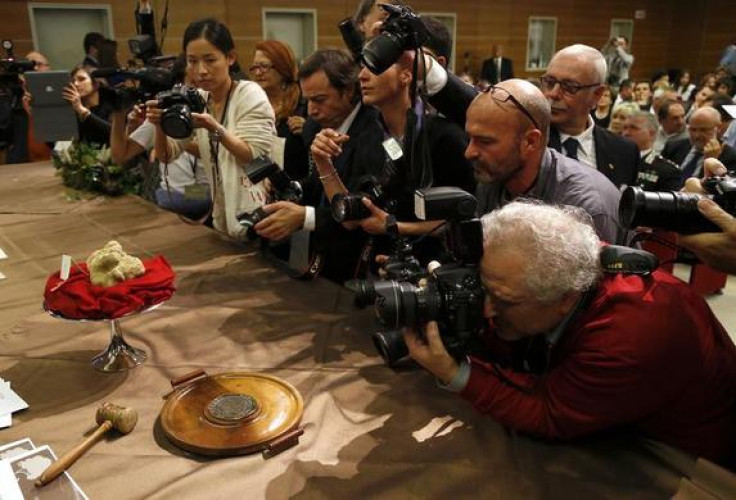 Photographers take pictures of two truffles weighing 2.09 pounds during the World Alba White Truffle Auction in Grinzane Cavour near Alba, in north-western Italy, November 10, 2013. The two biggest truffles at the auction sold for 90,000 euros (about $120
