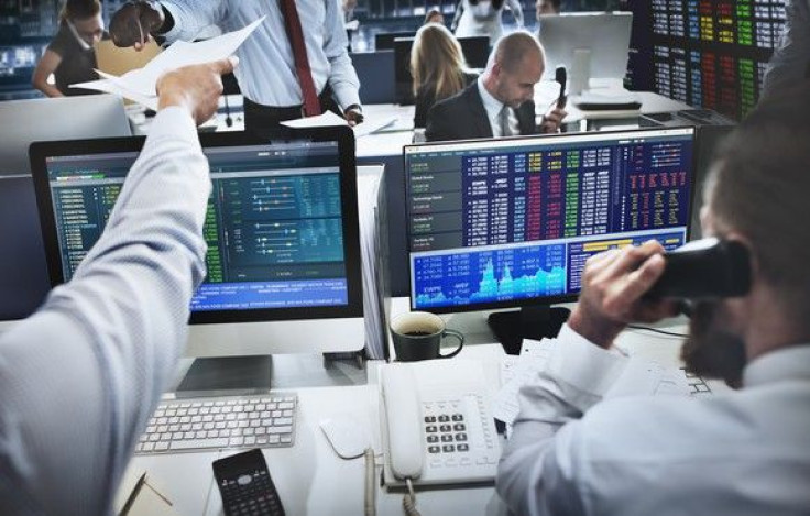 stock-traders-in-front-of-computers-on-phone-getty_large