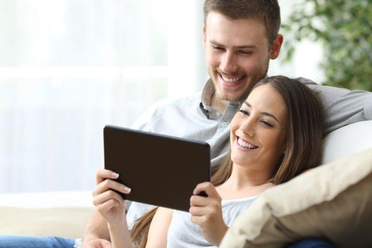 couple-watching-media-in-a-tablet_large