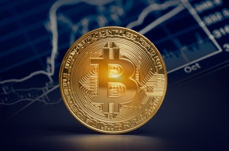 shiny-gold-bitcoin-with-market-graph-background_large
