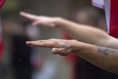 Members of a white supremacy group give the fascist salute