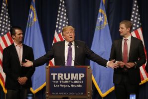  Donald Trump gestures to his sons Donald Trump Jr. (L) and Eric Trump (R) 