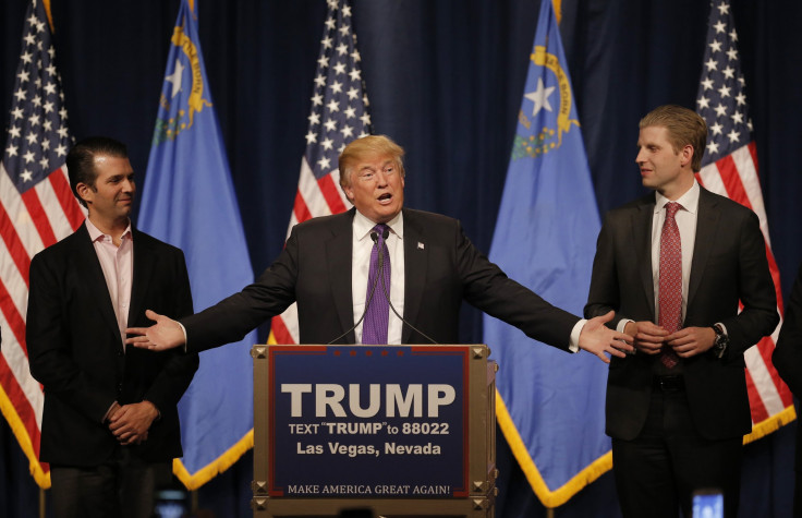  Donald Trump gestures to his sons Donald Trump Jr. (L) and Eric Trump (R) 