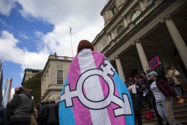 Activists wear transgender flag