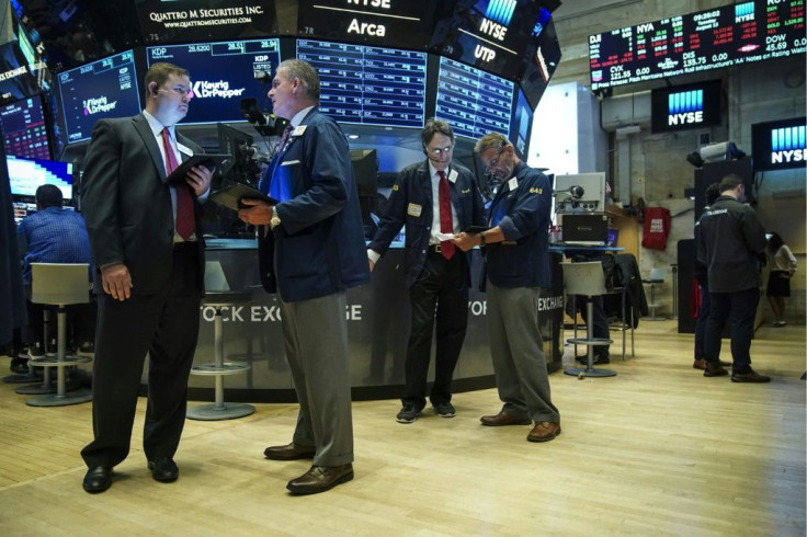 Traders work on the floor of the New York Stock Exchange at the opening bell on August 13, 2019 in New York City