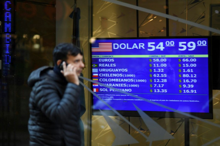 Currency exchange values are displayed on the buy-sell board in Buenos Aires, on August 13, 2019
