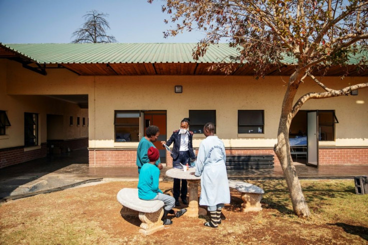 TB patients participate in painting activities with a caretaker in the garden of Ward 16, where the drug-resistant tuberculosis patients are housed and treated, on August 5, 2019, at the Sizwe Tropical Diseases Hospital in Johannesburg