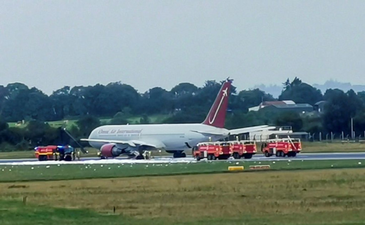 Firecrews attend an Omni Air International aircraft on the tarmac at Shannon Airport in County Clare, western Ireland, after a fire broke out on the undercarriage of the plane on the runway