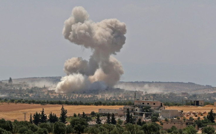 Smoke billows during a reported air strike by Syrian pro-regime forces near the town of Hish in Idlib province on August 19, 2019