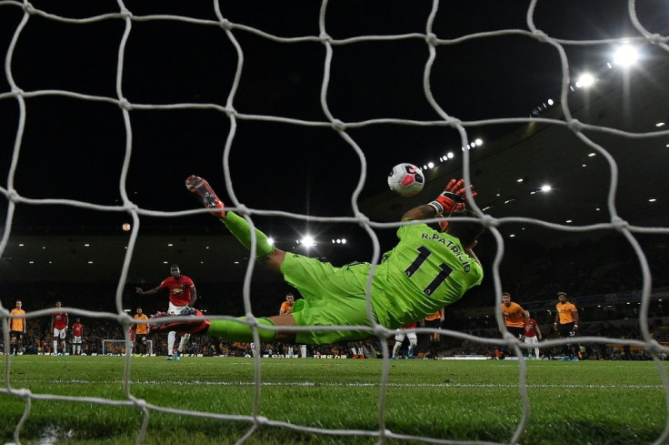 Wolves goalkeeper Rui Patricio (R) saves a penalty from Manchester United's Paul Pogba forcing United to settle for a 1-1 draw