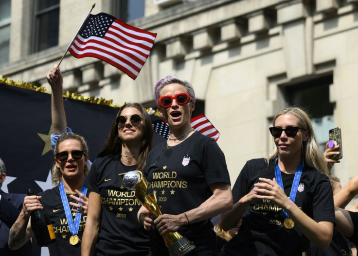 In this photo taken on July 10, 2019 Megan Rapinoe (C) and other members of the World Cup-winning US women's team take part in a ticker tape parade in New York