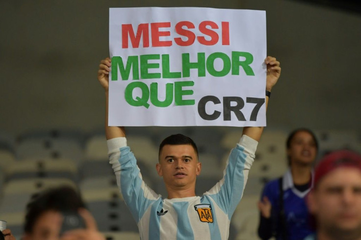 A fan of Argentina displays a placard reading "Messi better than CR7" at the start of the Copa America match against Paraguay in June