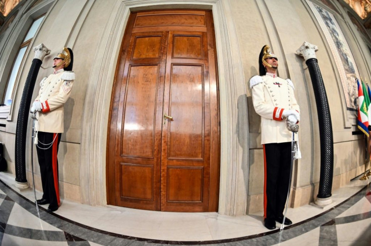 Italian elite military presidential officers stand guard outside the Quirinal palace in Rome as President Sergio Mattarella holds consultations