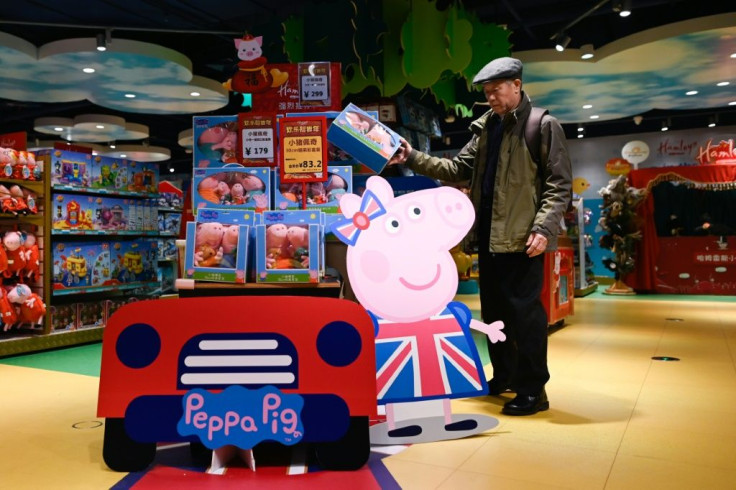 A man he selects a Peppa Pig toy at a store in Beijing
