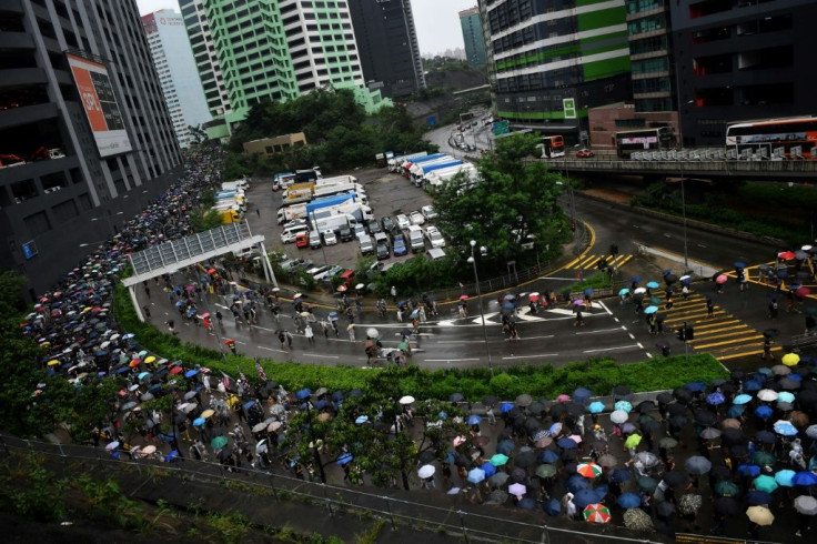 Thousands of people who had gathered at a sports stadium marched in the pouring rain to Tsuen Wan in Hong Kong