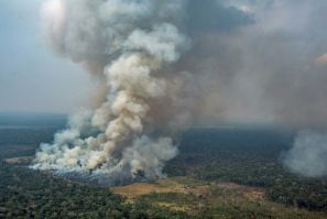 Handout aerial picture released by Greenpeace showing smoke billowing from forest fires in the municipality of Candeias do Jamari, close to Porto Velho in Rondonia State, in the Amazon basin in northwestern Brazil, on August 24, 2019