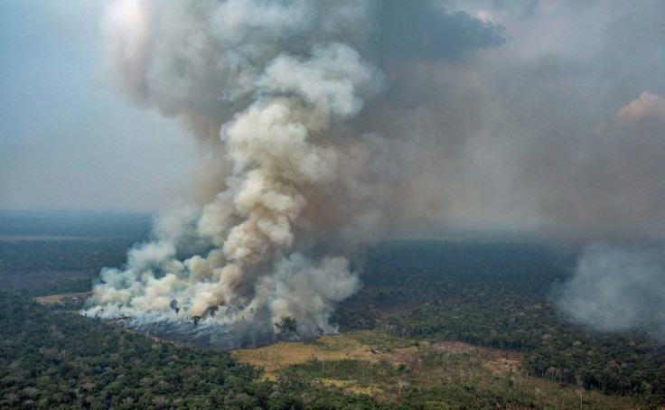 Handout aerial picture released by Greenpeace showing smoke billowing from forest fires in the municipality of Candeias do Jamari, close to Porto Velho in Rondonia State, in the Amazon basin in northwestern Brazil, on August 24, 2019