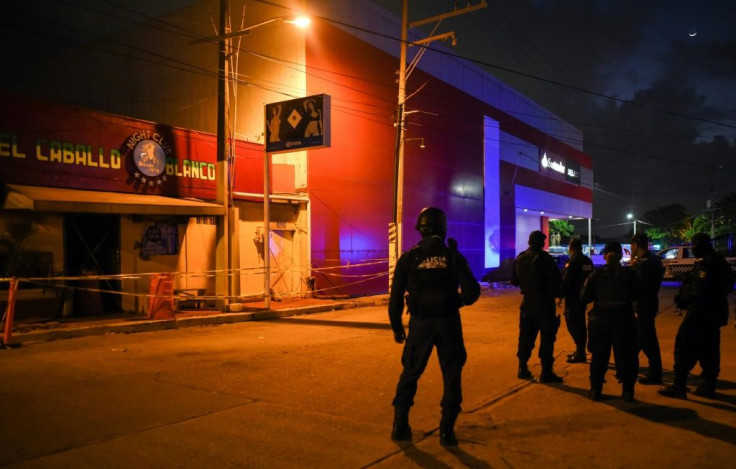 Police officers stand guard outside the Caballo Blanco, a bar where 25 people were killed by a fire in Coatzacoalcos, Mexico