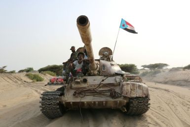 Fighters of the UAE-trained Security Belt Force, dominated by fighters of the Southern Transitional Council (STC) which seeks independence, ride atop a tank flying the flag of the former South Yemen in the coastal town of Shuqrah