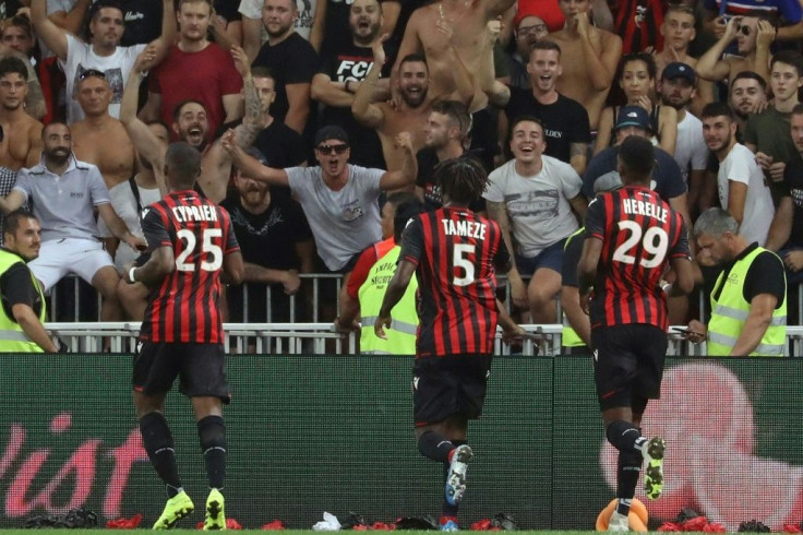 Nice players speak with supporters after their match with Marseille was suspended for homophobic chanting