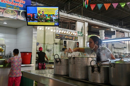 A TV in a market in Cali, Colombia, broadcasts a video posted on YouTube on August 29, 2019 of former senior commander Ivan Marquez and fellow rebel Jesus Santrich announcing that they are taking up arms again