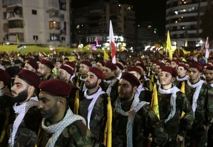 Fighters with the Lebanese Shiite Hezbollah party parade in a suburb of Beirut in May 2019