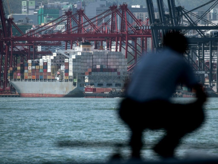 In this file photo taken on May 14, 2019, a man looks at shipping containers at a terminal in Hong Kong -- the US Treasury has slapped penalties on Taiwan and Hong Kong-based shipping firms said to help North Korea circumvent UN sanctions
