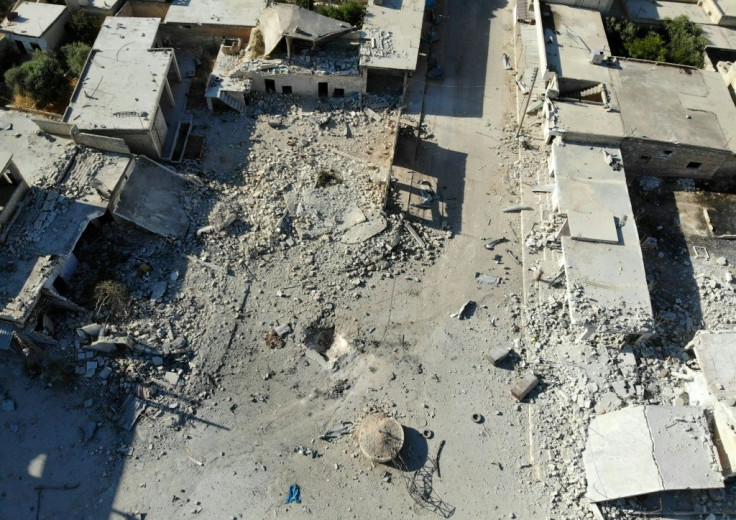 Destruction and damaged buildings from Syrian government forces' bombardment on the village of Al-Tahh in the northwestern Idlib province
