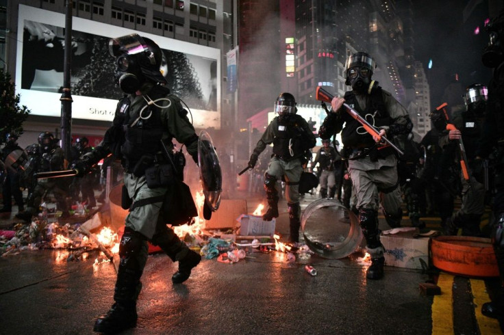 Debris set ablaze by demonstrators was no impediment for riot police as they chased protesters in Hong Kong's Causeway Bay district